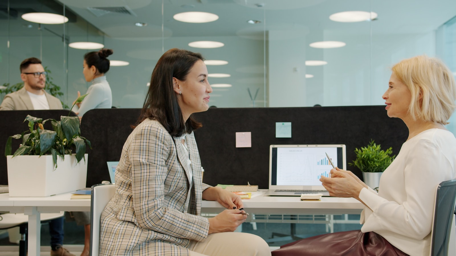 A specialist talking a client through their options at a desk